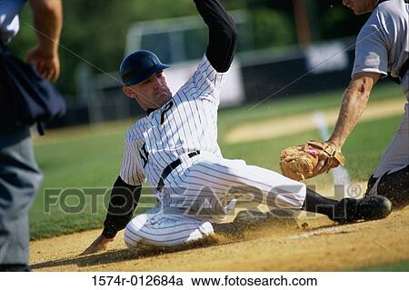 Stock Image - Baseball player sliding onto base. Fotosearch
