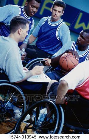 Stock Photography - Basketball players and their coach in a huddle. Fotosearch