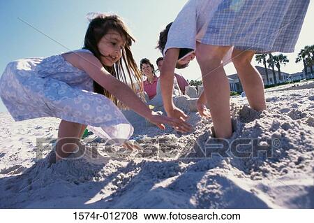 Boy and girl playing with sand View Large Photo Image Stock Photo - Boy and girl playing with sand. Fotosearch