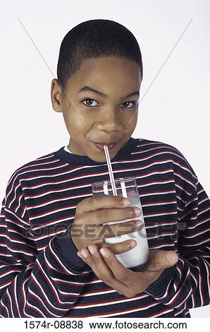 Stock Photo - Boy drinking milk from a glass. Fotosearch