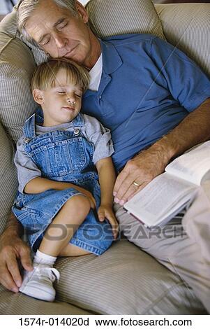 Stock Image - Boy sleeping with his grandfather. Fotosearch