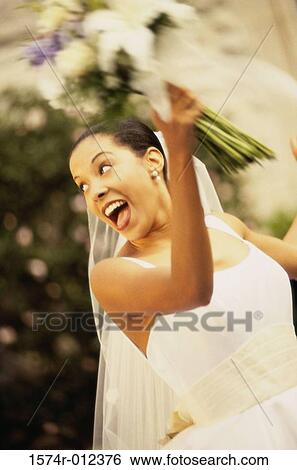 Bride tossing a bouquet of flowers View Large Photo Image Stock Photograph - Bride tossing a bouquet of flowers. Fotosearch