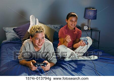 Brother and sister playing video games View Large Photo Image Stock Image - Brother and sister playing video games. Fotosearch