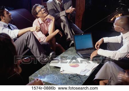 Stock Image - Business executives discussing work in a meeting. Fotosearch