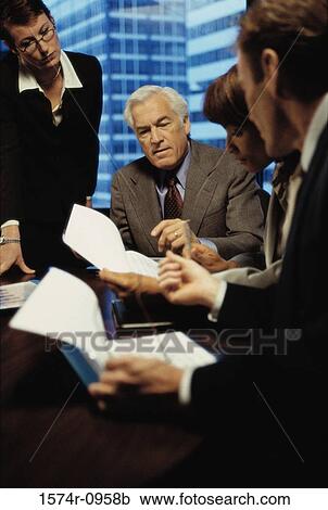 Stock Image - Business executives in a meeting. Fotosearch