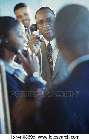 Business executives using pay phones View Large Photo Image Stock Image - Business executives using pay phones. Fotosearch
