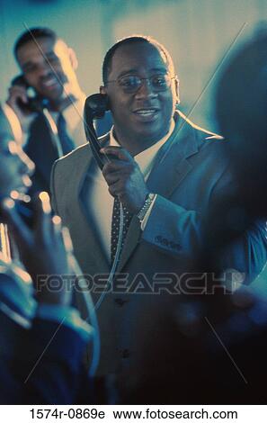 Business executives using pay phones View Large Photo Image Stock Image - Business executives using pay phones. Fotosearch