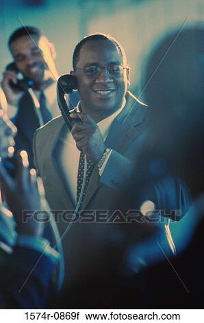 Business executives using pay phones View Large Photo Image Stock Image - Business executives using pay phones. Fotosearch
