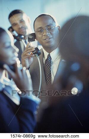 Business executives using pay phones View Large Photo Image Stock Image - Business executives using pay phones. Fotosearch