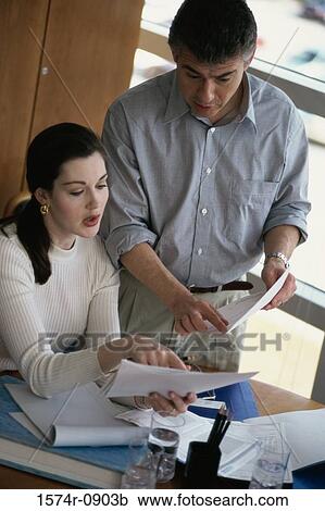 Businessman and a businesswoman in a meeting View Large Photo Image Stock Image - Businessman and a businesswoman in a meeting. Fotosearch