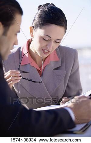 Businessman and a businesswoman discussing View Large Photo Image Picture - Businessman and a businesswoman discussing. Fotosearch