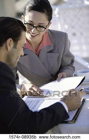 Businessman and a businesswoman talking in a restaurant View Large Photo Image Stock Image - Businessman and a businesswoman talking in a restaurant. Fotosearch