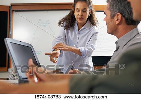 Businessman and a businesswoman working in front of a computer monitor View Large Photo Image Stock Image - Businessman and a businesswoman working in front of a computer monitor. Fotosearch