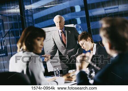 Businessman giving a presentation in a meeting View Large Photo Image Stock Image - Businessman giving a presentation in a meeting. Fotosearch