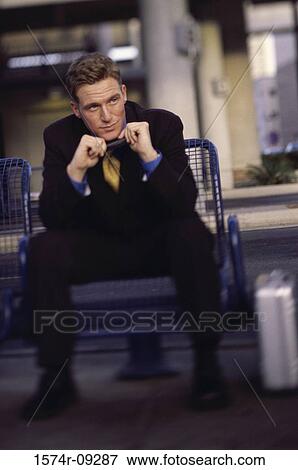 Businessman sitting on a bench View Large Photo Image Stock Photo - Businessman sitting on a bench. Fotosearch