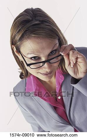 Stock Image - Businesswoman adjusting her eyeglasses. Fotosearch