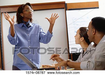 Businesswoman discussing in an office View Large Photo Image Stock Photo - Businesswoman discussing in an office. Fotosearch