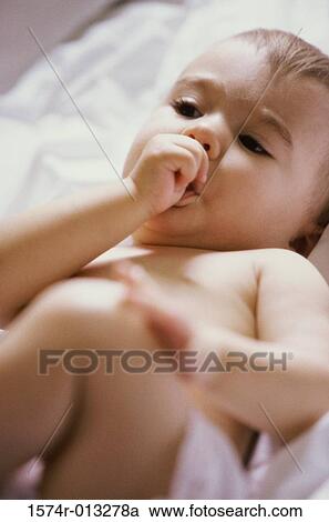 Close-up of a baby boy sucking his thumb View Large Photo Image Stock Image - Close-up of a baby boy sucking his thumb. Fotosearch
