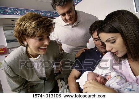 Stock Photograph - Close-up of a baby boy with his parents and grandparents in a hospital. Fotosearch