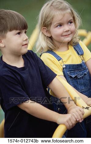 Close-up of a boy and girl on a merry-go-round View Large Photo Image Stock Image - Close-up of a boy and girl on a merry-go-round. Fotosearch