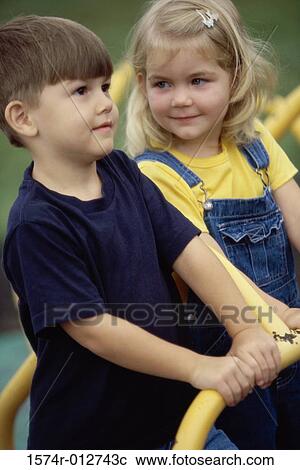 Close-up of a boy and girl on a merry-go-round View Large Photo Image Stock Image - Close-up of a boy and girl on a merry-go-round. Fotosearch