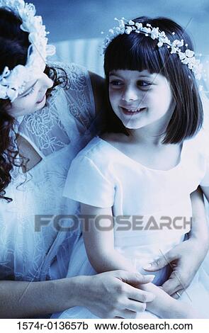 Close-up of a bride sitting with a flower girl View Large Photo Image Stock Image - Close-up of a bride sitting with a flower girl. Fotosearch