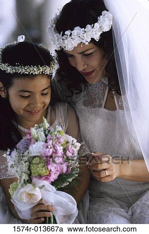Close-up of a bride sitting with a flower girl View Large Photo Image Stock Image - Close-up of a bride sitting with a flower girl. Fotosearch