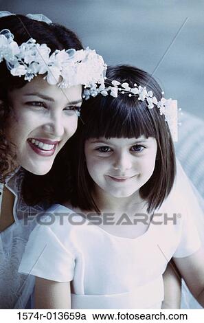 Close-up of a bride with a flower girl View Large Photo Image Stock Image - Close-up of a bride with a flower girl. Fotosearch