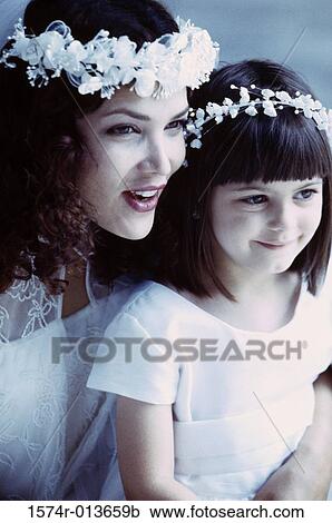 Close-up of a bride with a flower girl smiling View Large Photo Image Stock Image - Close-up of a bride with a flower girl smiling. Fotosearch