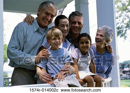 Stock Image - Close-up of a brother and sister with their parents and grandparents. Fotosearch