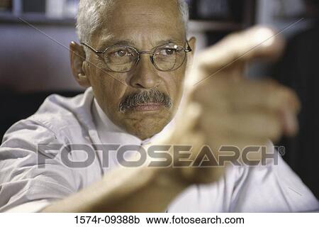 Close-up of a businessman pointing forward View Large Photo Image Stock Image - Close-up of a businessman pointing forward. Fotosearch