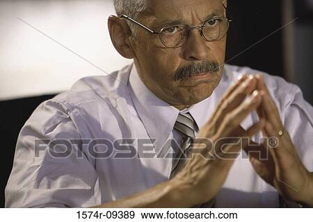 Close-up of a businessman thinking View Large Photo Image Stock Photo - Close-up of a businessman thinking. Fotosearch