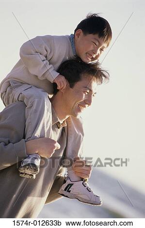 Close-up of a father carrying his son on his shoulders View Large Photo Image Stock Image - Close-up of a father carrying his son on his shoulders. Fotosearch