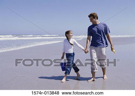 Close-up of a father carrying his daughter and smiling View Large Photo Image Stock Photo - Close-up of a father carrying his daughter and smiling. Fotosearch