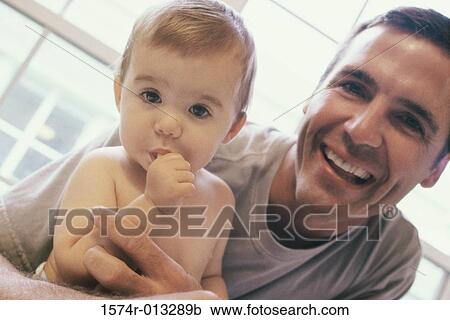 Stock Image - Close-up of a father feeding his daughter. Fotosearch