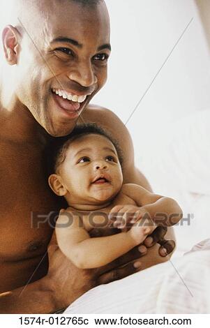 Close-up of a father holding his son View Large Photo Image Stock Image - Close-up of a father holding his son. Fotosearch