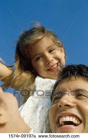 Close-up of a father holding his daughter View Large Photo Image Stock Image - Close-up of a father holding his daughter. Fotosearch