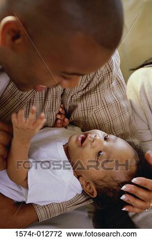 Stock Image - Close-up of a father looking at his daughter. Fotosearch