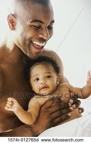 Close-up of a father playing with his son View Large Photo Image Stock Image - Close-up of a father playing with his son. Fotosearch