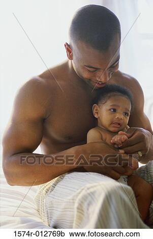 Stock Image - Close-up of a father playing with his son. Fotosearch