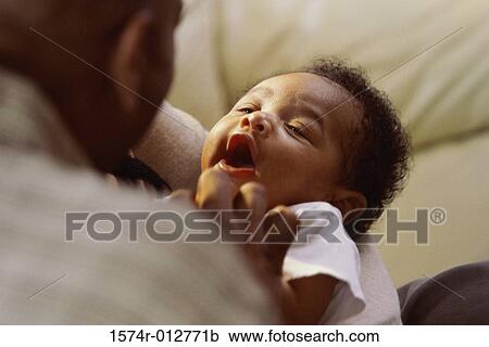 Close-up of a father playing with his son View Large Photo Image Stock Image - Close-up of a father playing with his son. Fotosearch