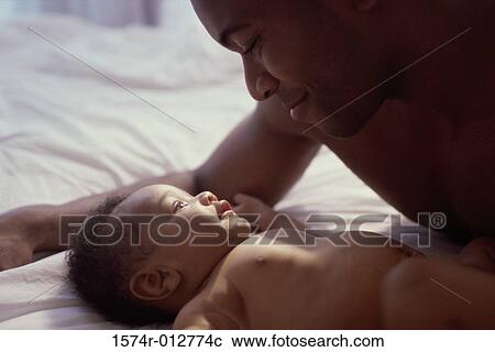 Close-up of a father playing with his son View Large Photo Image Stock Image - Close-up of a father playing with his son. Fotosearch