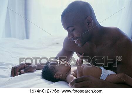 Close-up of a father playing with his son View Large Photo Image Stock Image - Close-up of a father playing with his son. Fotosearch