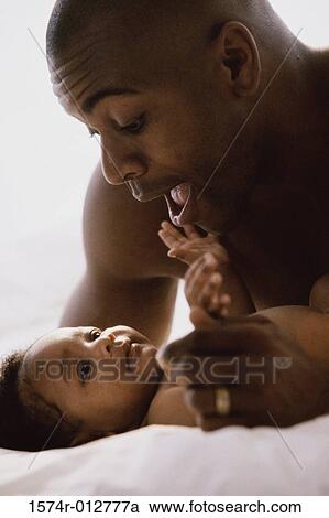 Stock Image - Close-up of a father playing with his son. Fotosearch
