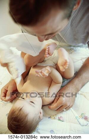 Stock Image - Close-up of a father playing with his son. Fotosearch