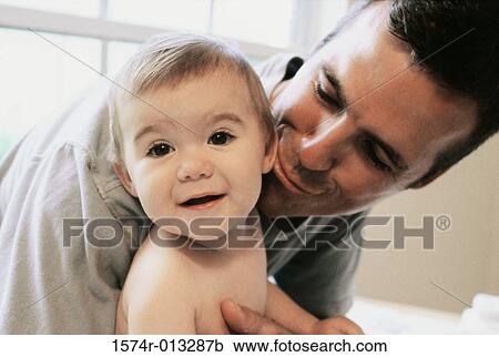 Close-up of a father playing with his son View Large Photo Image Stock Image - Close-up of a father playing with his son. Fotosearch