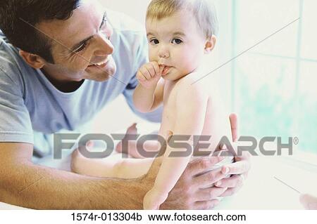 Close-up of a father playing with his son View Large Photo Image Stock Image - Close-up of a father playing with his son. Fotosearch