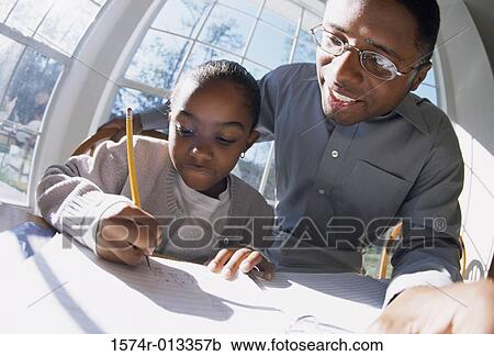 Close-up of a father teaching his daughter View Large Photo Image Stock Image - Close-up of a father teaching his daughter. Fotosearch