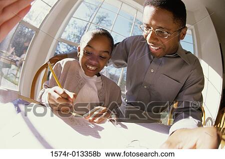 Close-up of a father teaching his daughter View Large Photo Image Stock Image - Close-up of a father teaching his daughter. Fotosearch