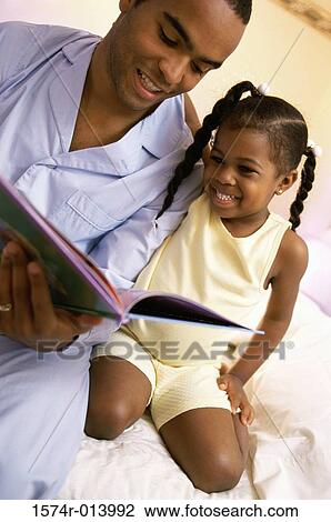 Close-up of a father teaching his daughter View Large Photo Image Stock Image - Close-up of a father teaching his daughter. Fotosearch